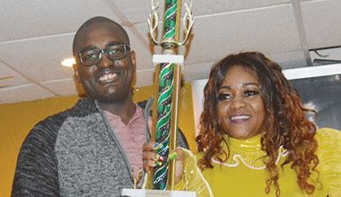 New Song Competition, and the first ever New Break-out Artiste winner Michelle 'Hibiscus' Hillocks (right) receiving trophy from Atiba Williams (left) Vice Chairman of the Cultural Association of Vincentians in the USA