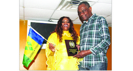 Hibiscus receives 'New Breakout Artist' plaque from singer/songwriter Cauldric Forbes.