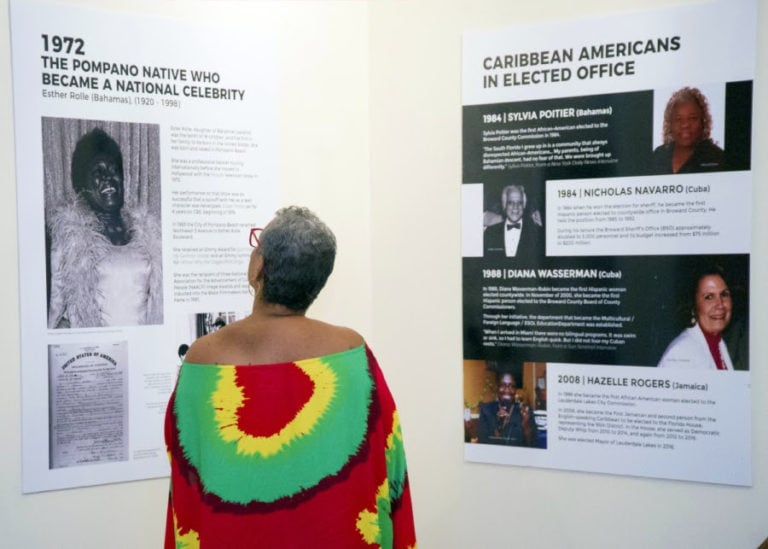 An attendee learning about South Florida’s Caribbean-American history at the 2019 art and history exhibition, Island Imprint | Photo: RJ Deed
