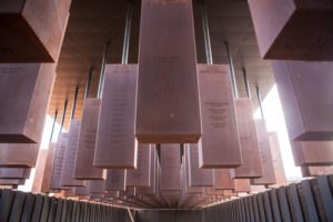 The Memorial Corridor at the National Memorial for Peace and Justice, which is the nation’s first memorial "dedicated to the legacy of enslaved Black people, people terrorized by lynching, African Americans humiliated by racial segregation and Jim Crow, and people of color burdened with contemporary presumptions of guilt and police violence." (Photo from Wikimedia Commons by Soniakapadia, CC BY-SA 4.0).