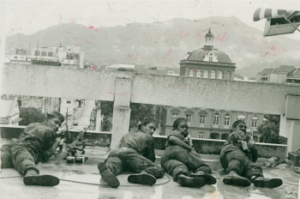 Image 1:TTDF Snipers on the roof of the Hall of Justice training their guns on the Red House during the attempted coup. (Source: The Trinidad and Tobago Guardian August 1990)